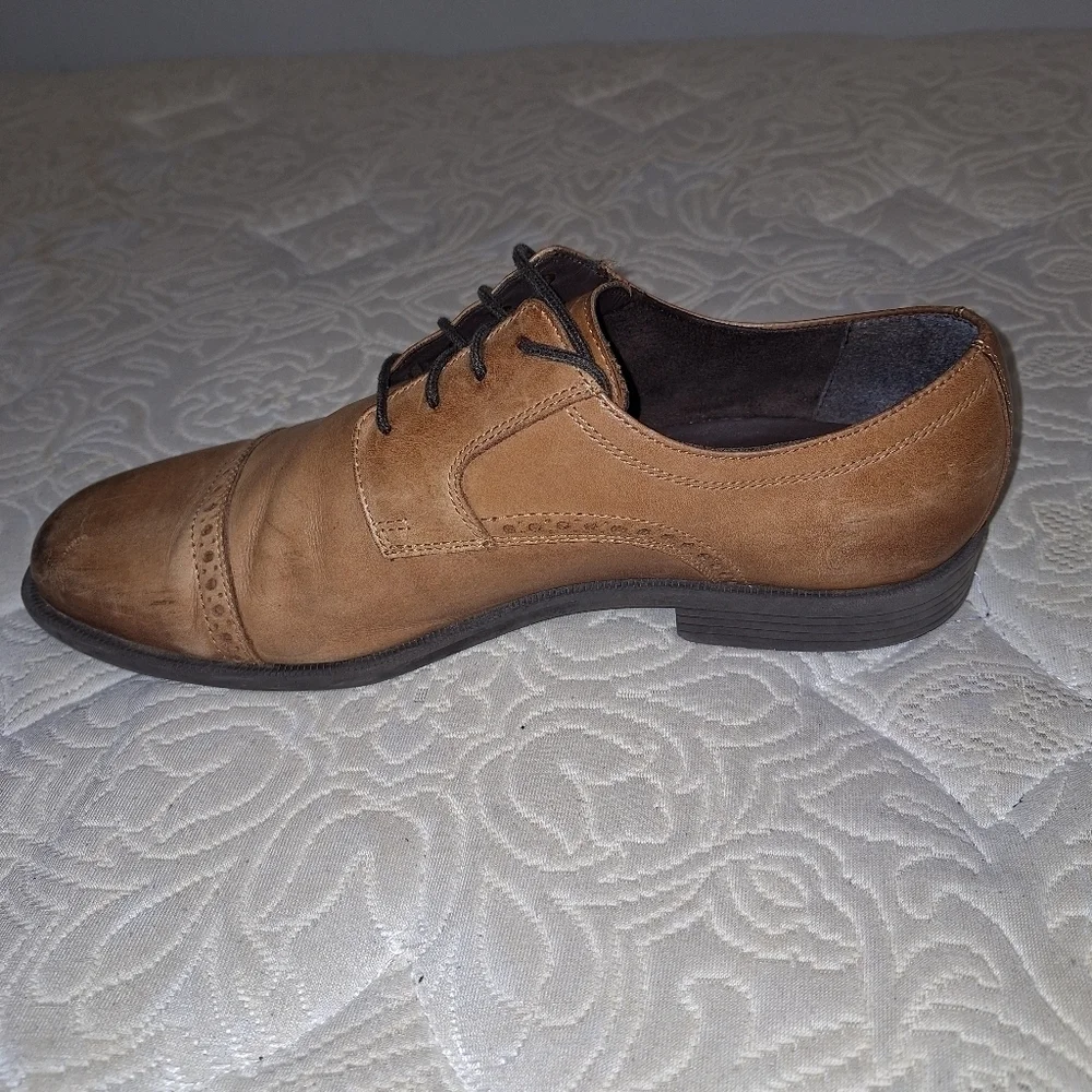 A pair of Cole Haan Oxfords in a men's size 12M. Pre-loved in good condition.